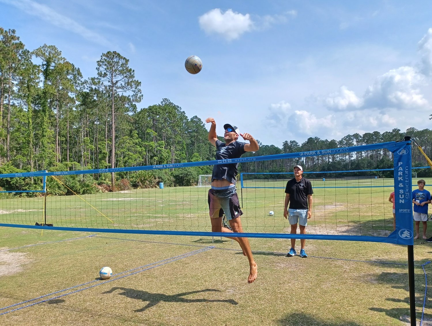 Olympic gold medalist Phil Dalhausser demonstrates the right way to spike the ball during a youth volleyball class at Nocatee Community Park.